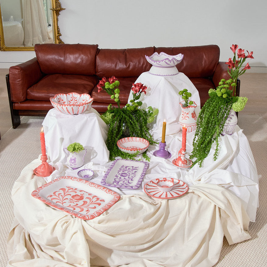 Living room with a table covered in white cloth, granada collection ceramic items, and a brown sofa.  - lifestyle