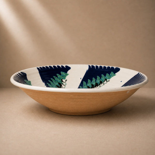 Ceramic bowl with decorative rim on a beige background