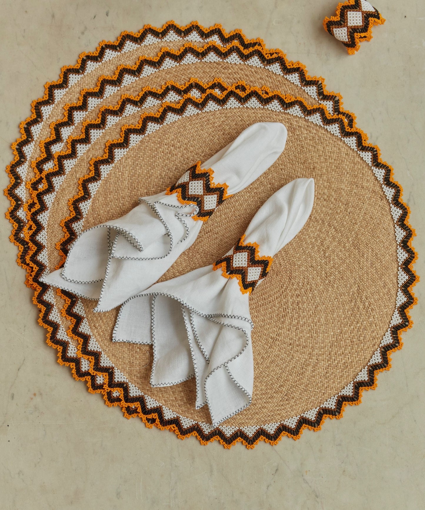 Alicia placemat in burnt yellow, handwoven iraca palm, overhead view