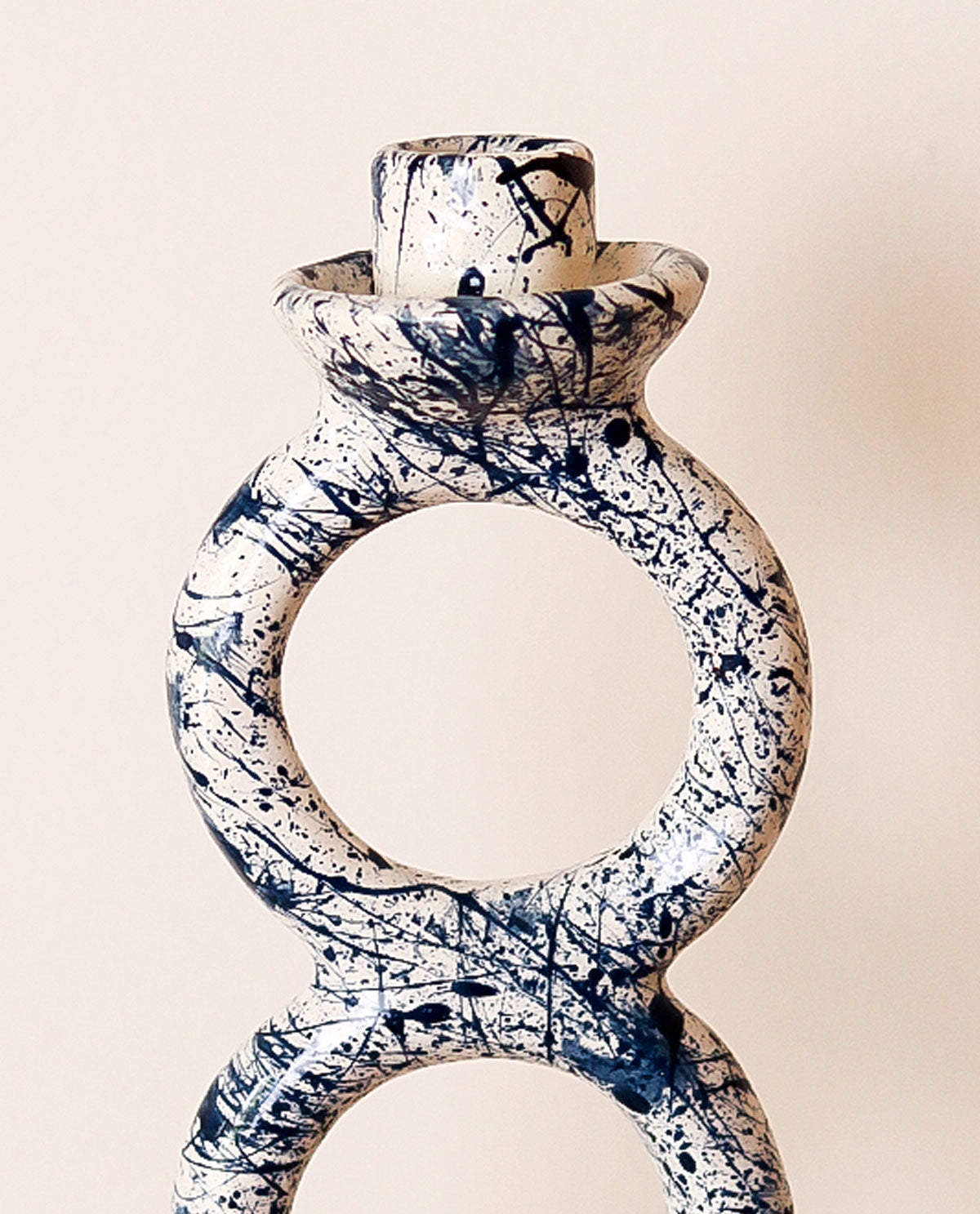 Splash blue and white candle holder on a beige background