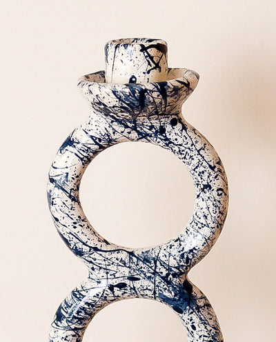 Splash blue and white candle holder on a beige background