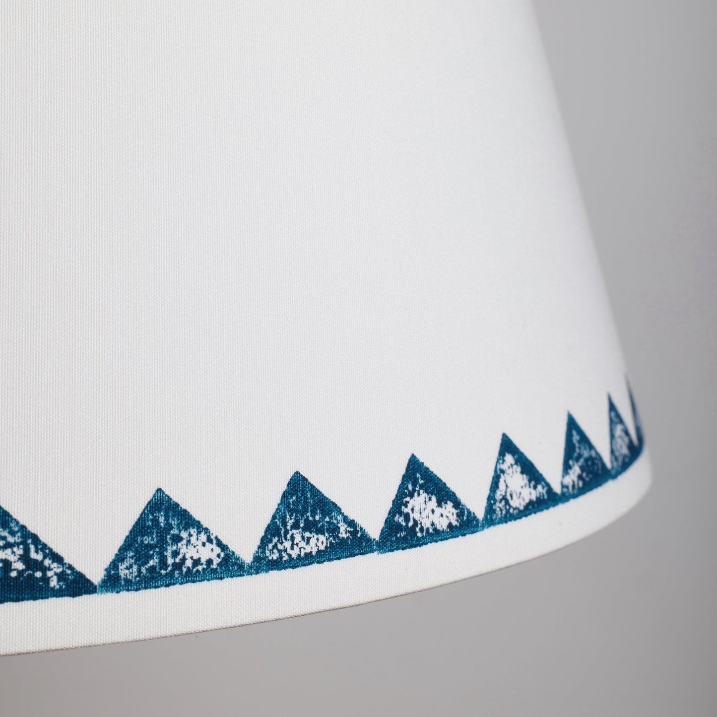 Detailed view Studio Zef's Trigon blue lampshade showing textured triangle motifs, a lampshade with triangle pattern that highlights the handmade detail.