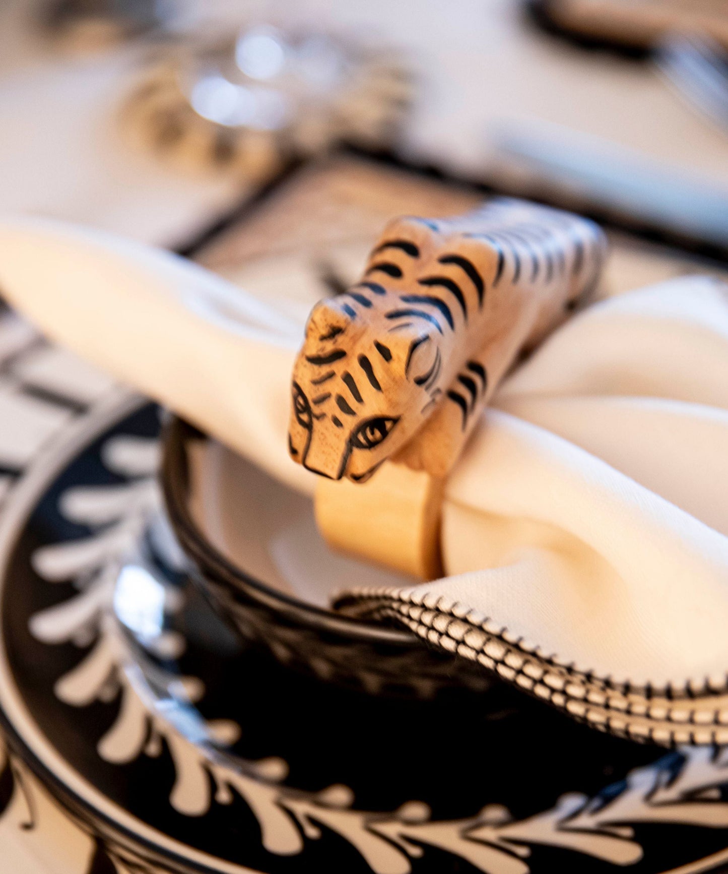 Felino Tiger napkin ring, hand-carved wood, on a table setting