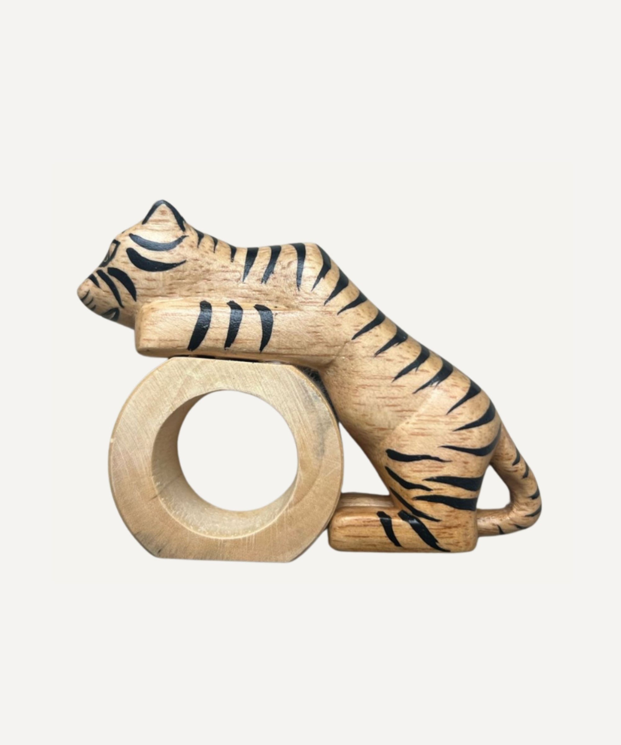 Felino Tiger napkin ring, hand-carved wood, holding a folded napkin