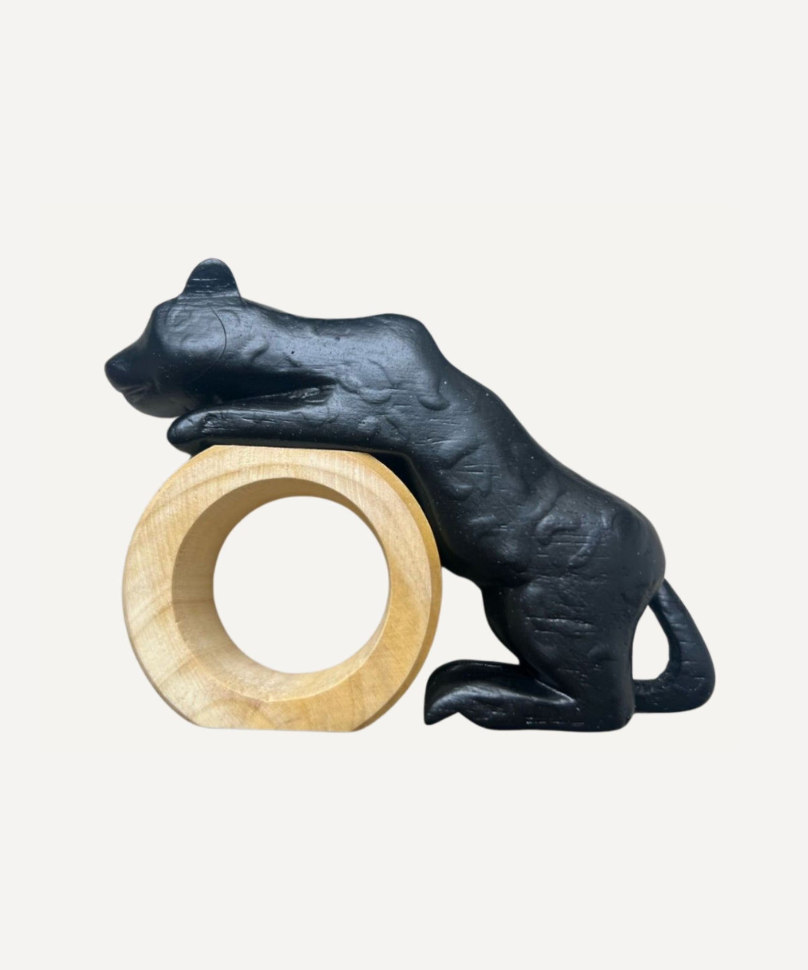 Felino Puma napkin ring, hand-carved wood, holding a folded napkin