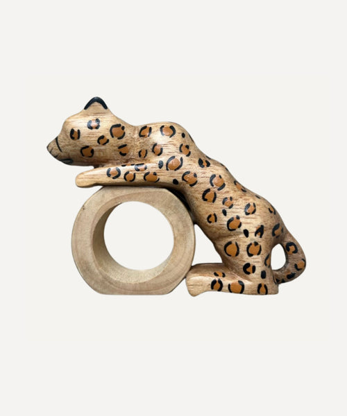 Felino Jaguar napkin ring, hand-carved wood, holding a folded napkin
