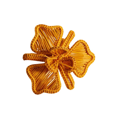 Orquidea napkin ring in mustard, handwoven iraca palm, holding a folded napkin