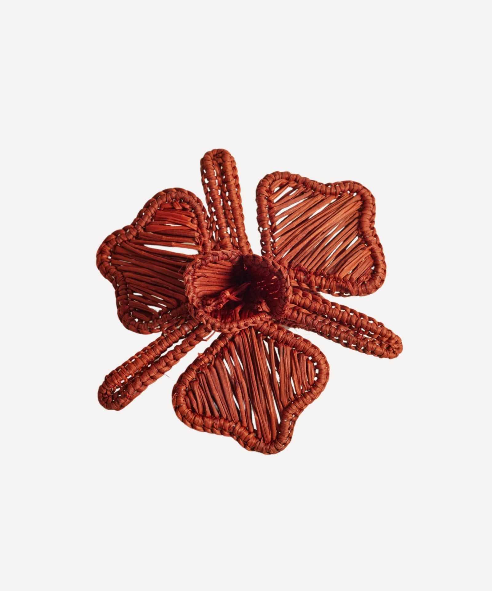 Orquidea napkin ring in terracotta, handwoven iraca palm, holding a folded napkin