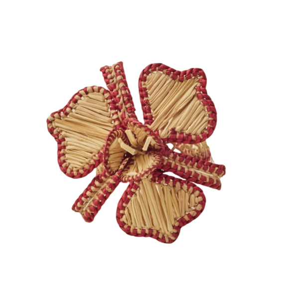 Orquidea napkin ring with a framboise border, handwoven iraca palm, holding a folded napkin