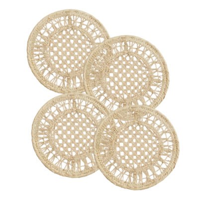 Joy coasters, set of four, handwoven iraca palm, on a table