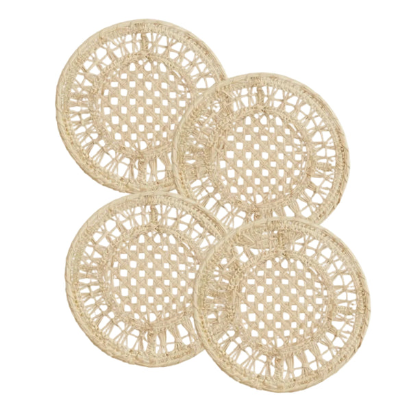 Joy coasters, set of four, handwoven iraca palm, on a table