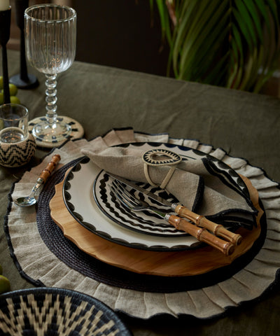 Arandela placemat in sand, iraca palm and linen, overhead view