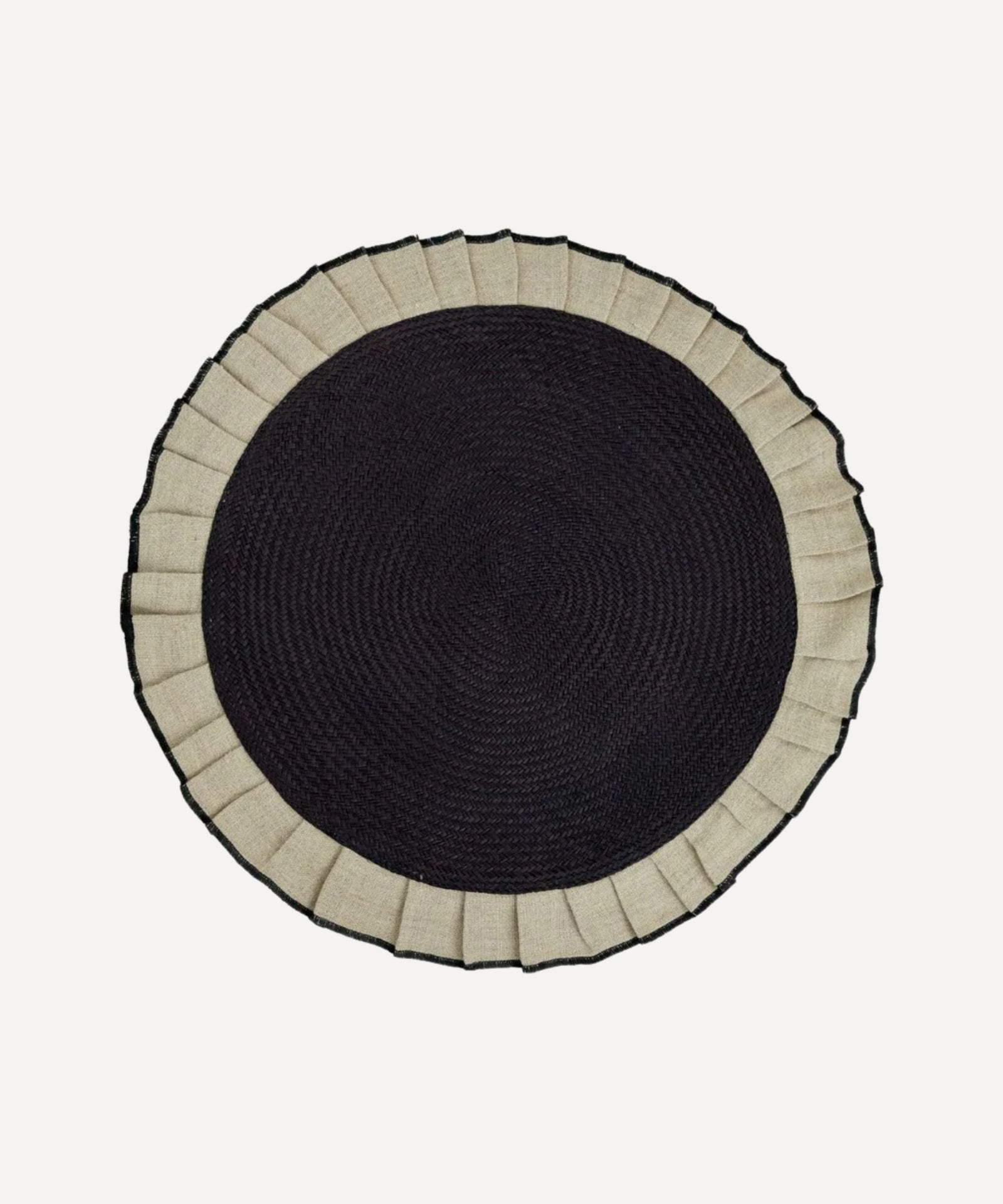 Arandela placemat in sand, handwoven iraca palm and linen, styled on a table
