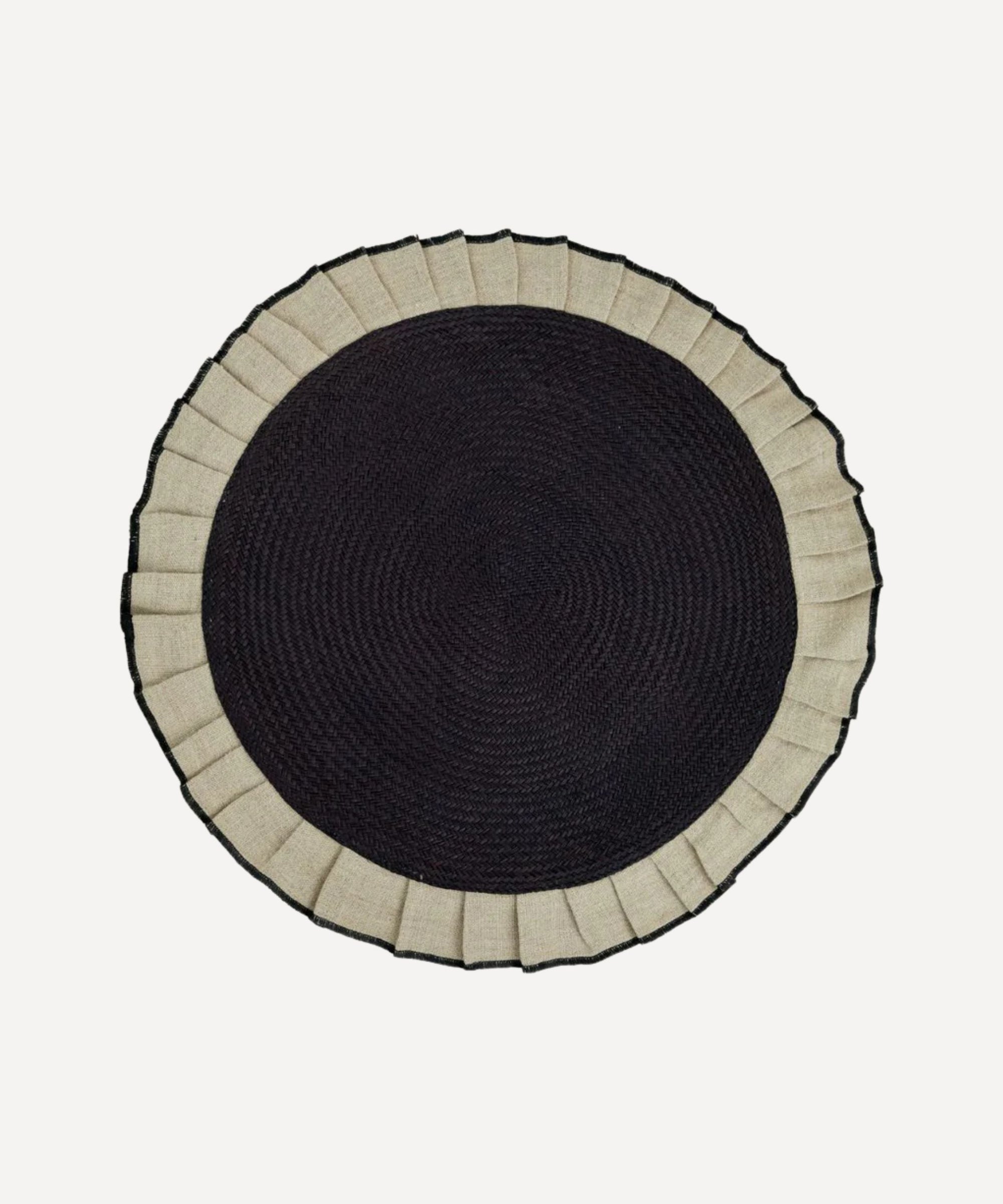 Arandela placemat in sand, handwoven iraca palm and linen, styled on a table