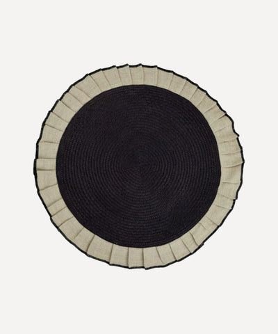 Arandela placemat in sand, handwoven iraca palm and linen, styled on a table