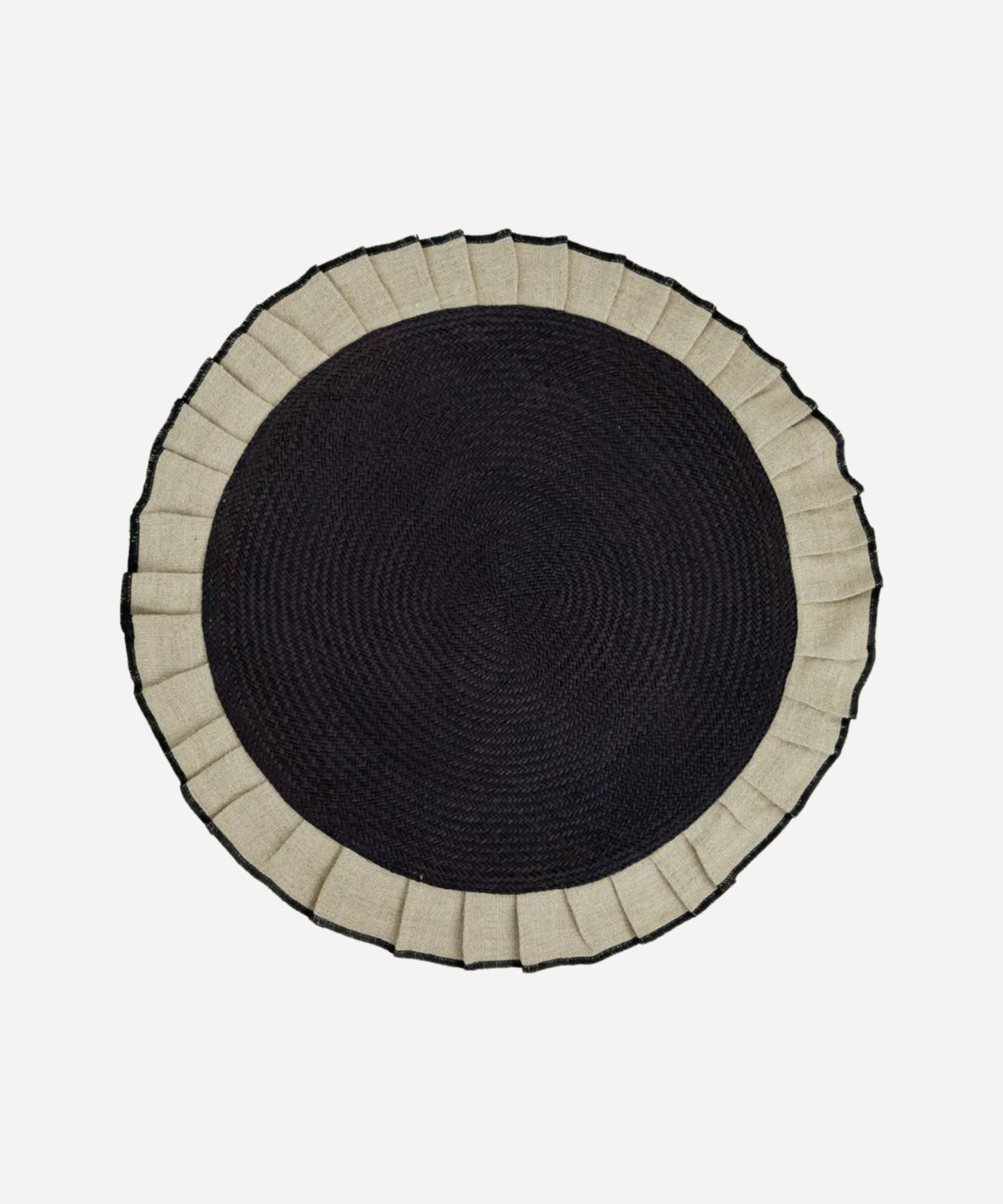 Arandela placemat in sand, handwoven iraca palm and linen, styled on a table