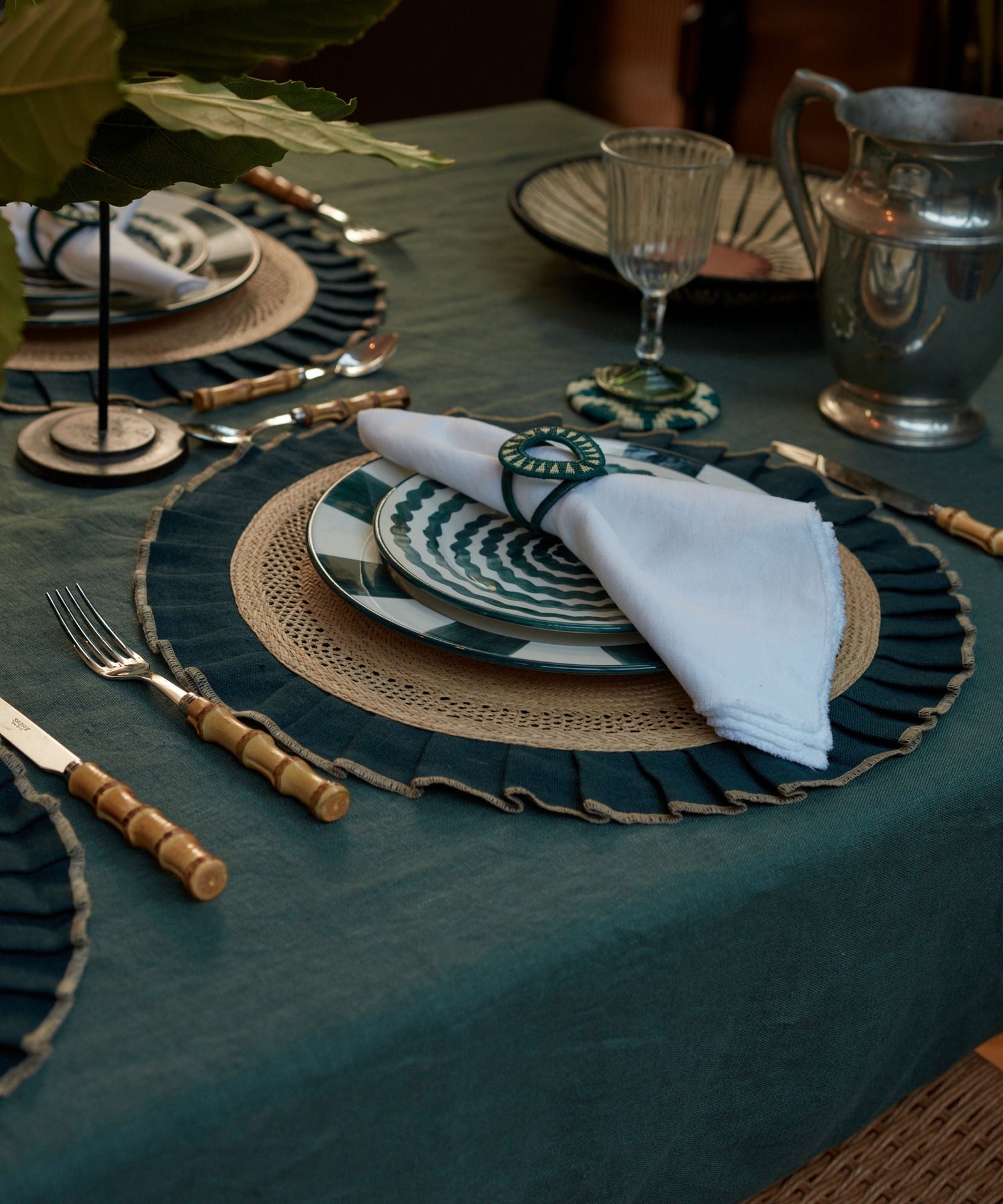 Teal handwoven tableware from Colombia, styled on a table setting