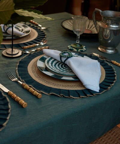 Teal handwoven tableware from Colombia, styled on a table setting