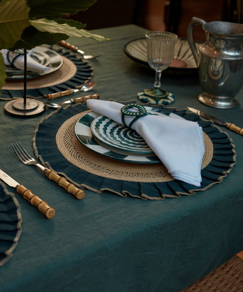 Teal handwoven tableware from Colombia, styled on a table setting