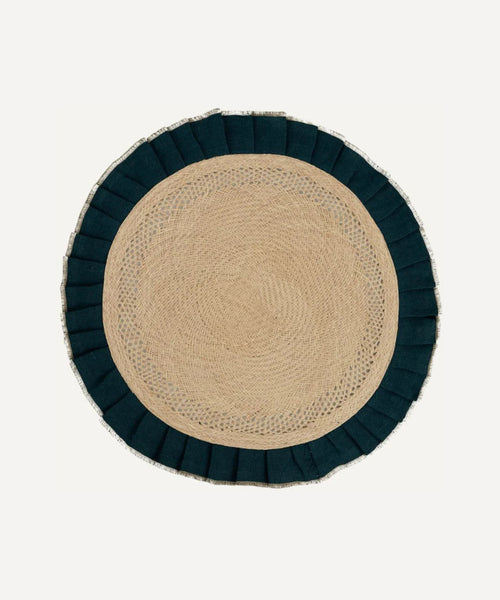 Arandela placemat in teal, handwoven iraca palm and linen, styled on a table