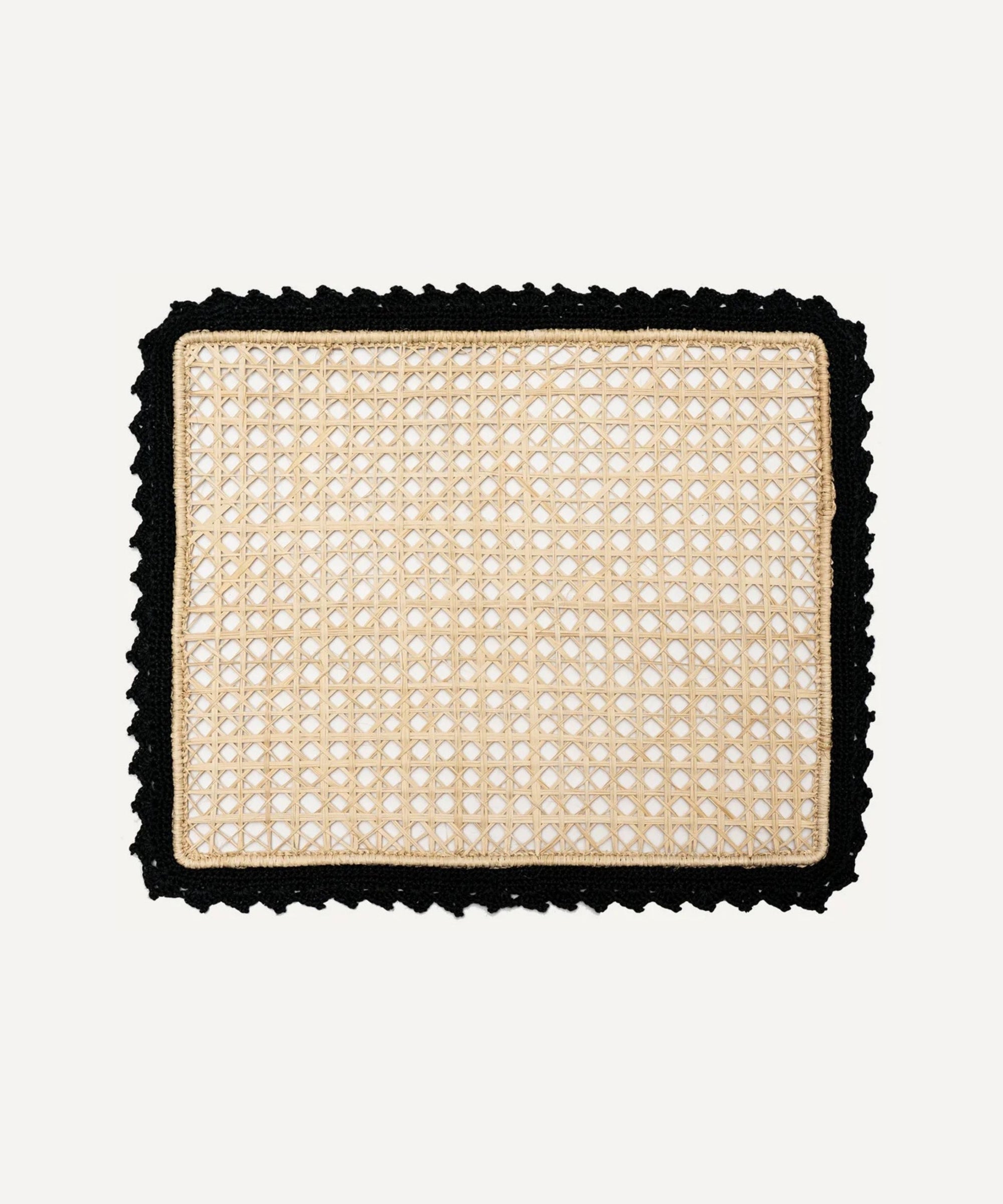 Nubia placemat in black, handwoven iraca palm, styled on a table