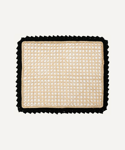 Nubia placemat in black, handwoven iraca palm, styled on a table