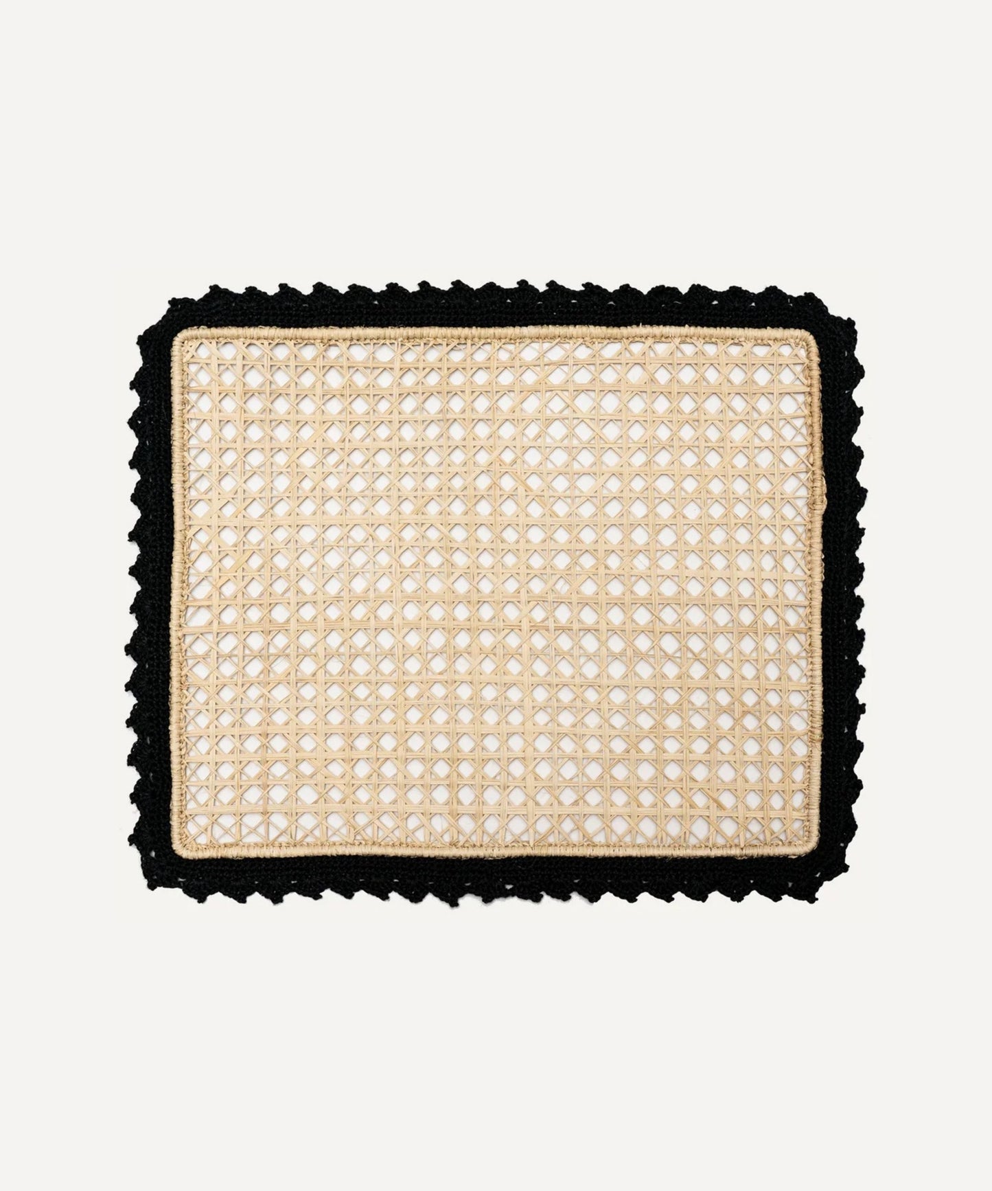 Nubia placemat in black, handwoven iraca palm, styled on a table