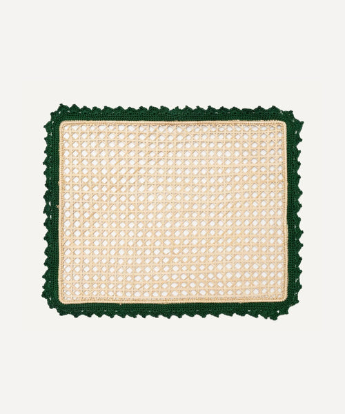 Nubia placemat in green, handwoven iraca palm, styled on a table