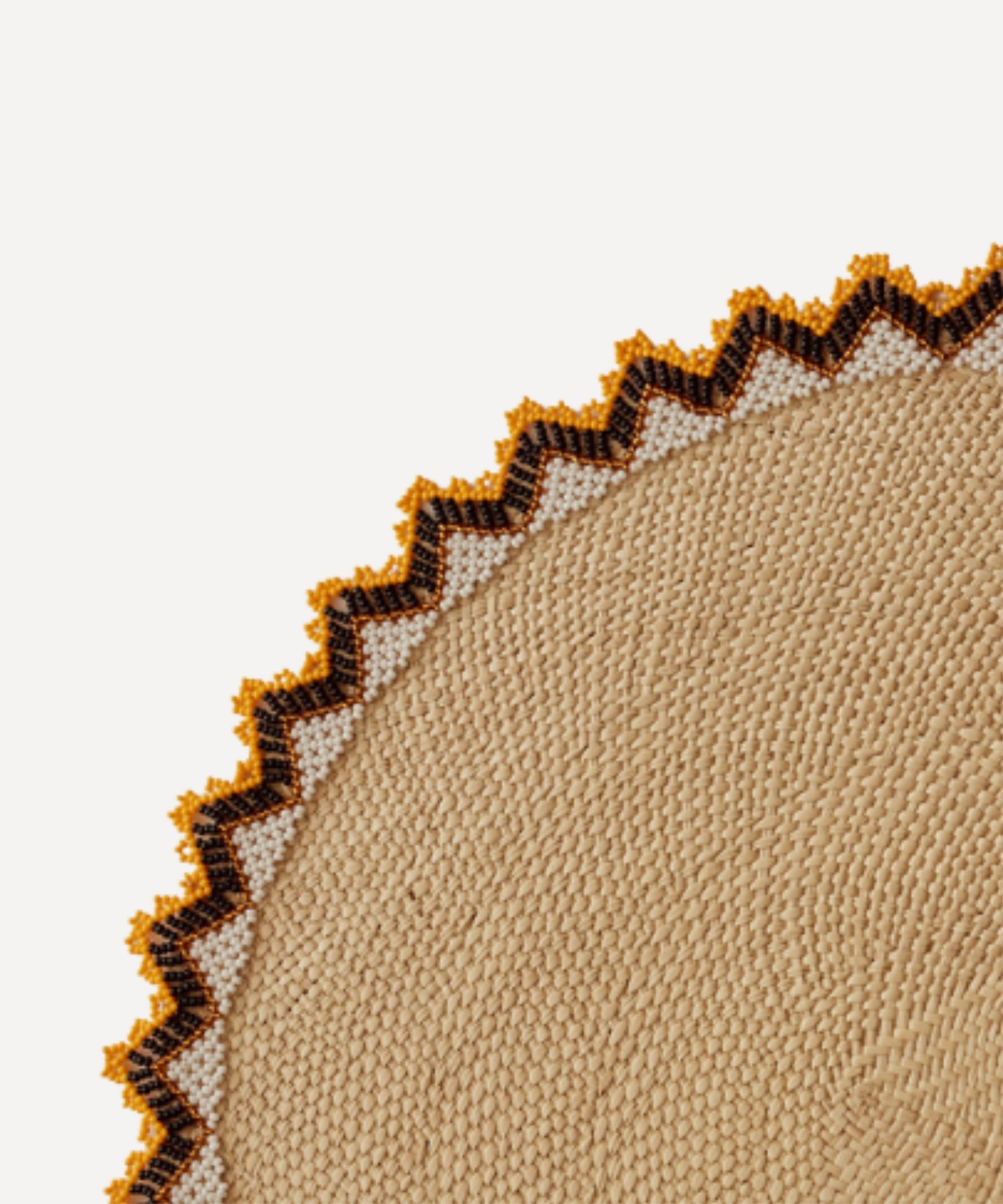 Alicia placemat in burnt yellow, close-up of the iraca palm weave
