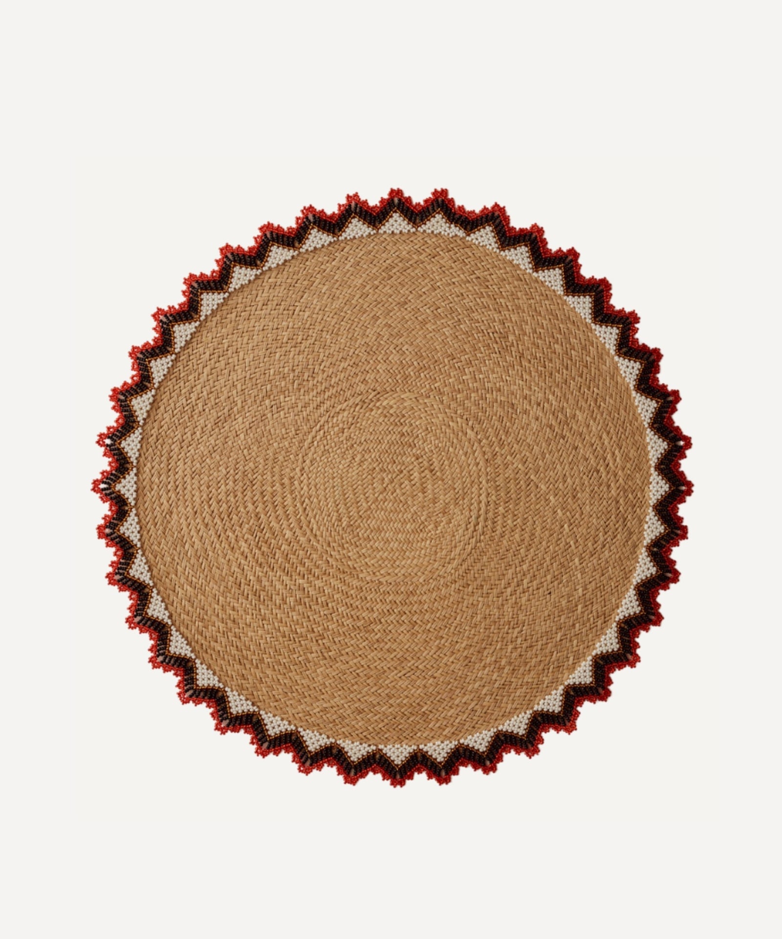 Alicia placemat in bright red, handwoven iraca palm, styled on a table