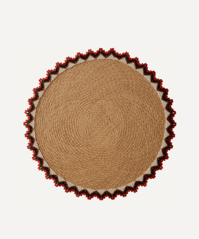Alicia placemat in bright red, handwoven iraca palm, styled on a table