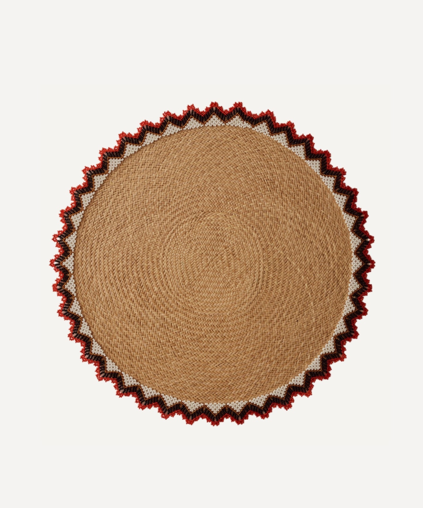 Alicia placemat in bright red, handwoven iraca palm, styled on a table