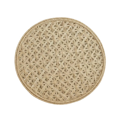 Cruces cross-weave placemat in natural, handwoven iraca palm, on a table