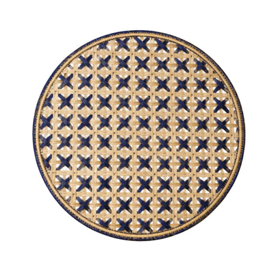 Cruces cross-weave placemat in deep blue, handwoven iraca palm, on a table