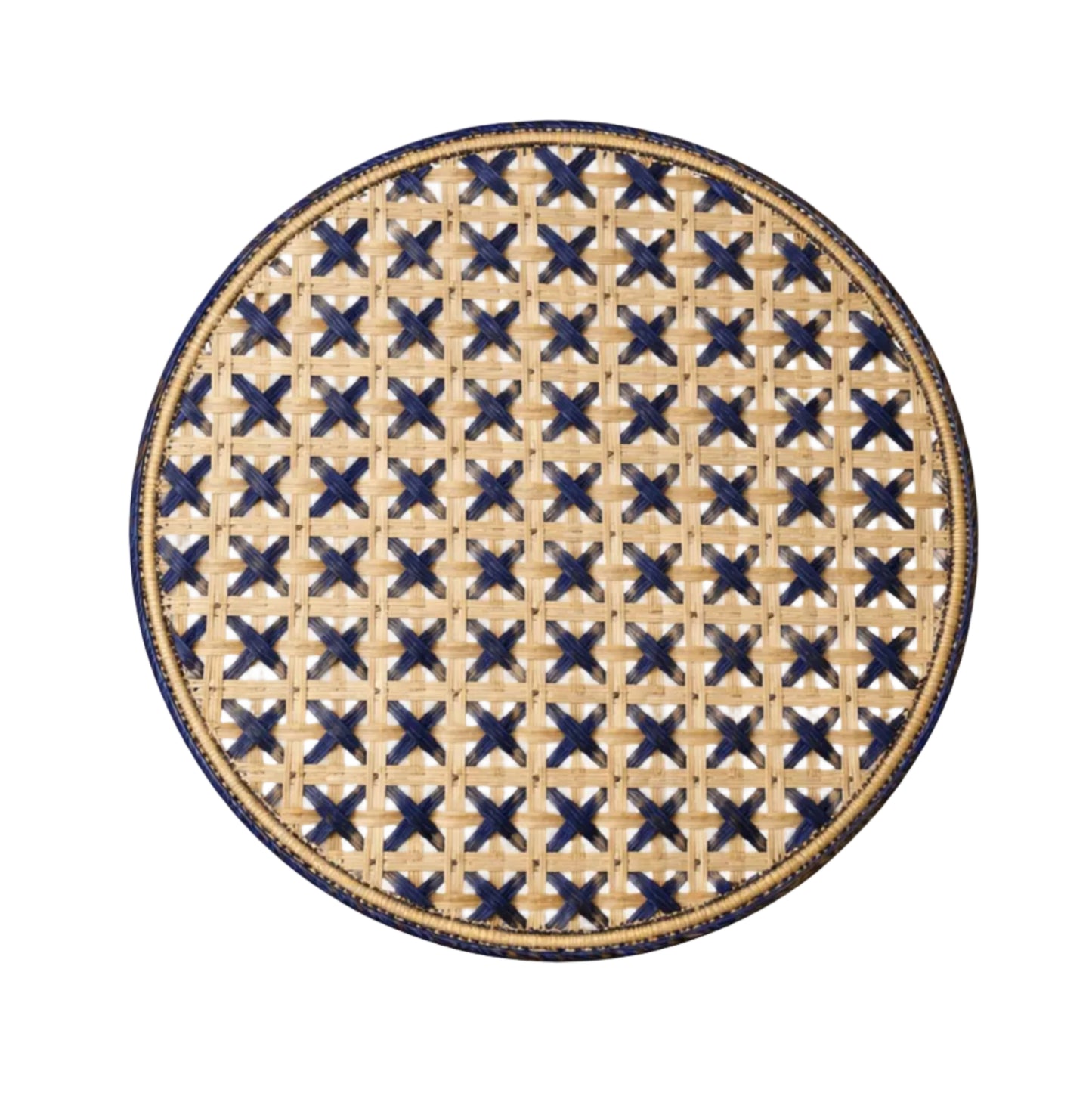Cruces cross-weave placemat in deep blue, handwoven iraca palm, on a table