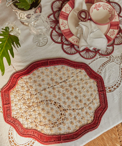 Deco geometric placemat in marsala, handwoven iraca palm, overhead view