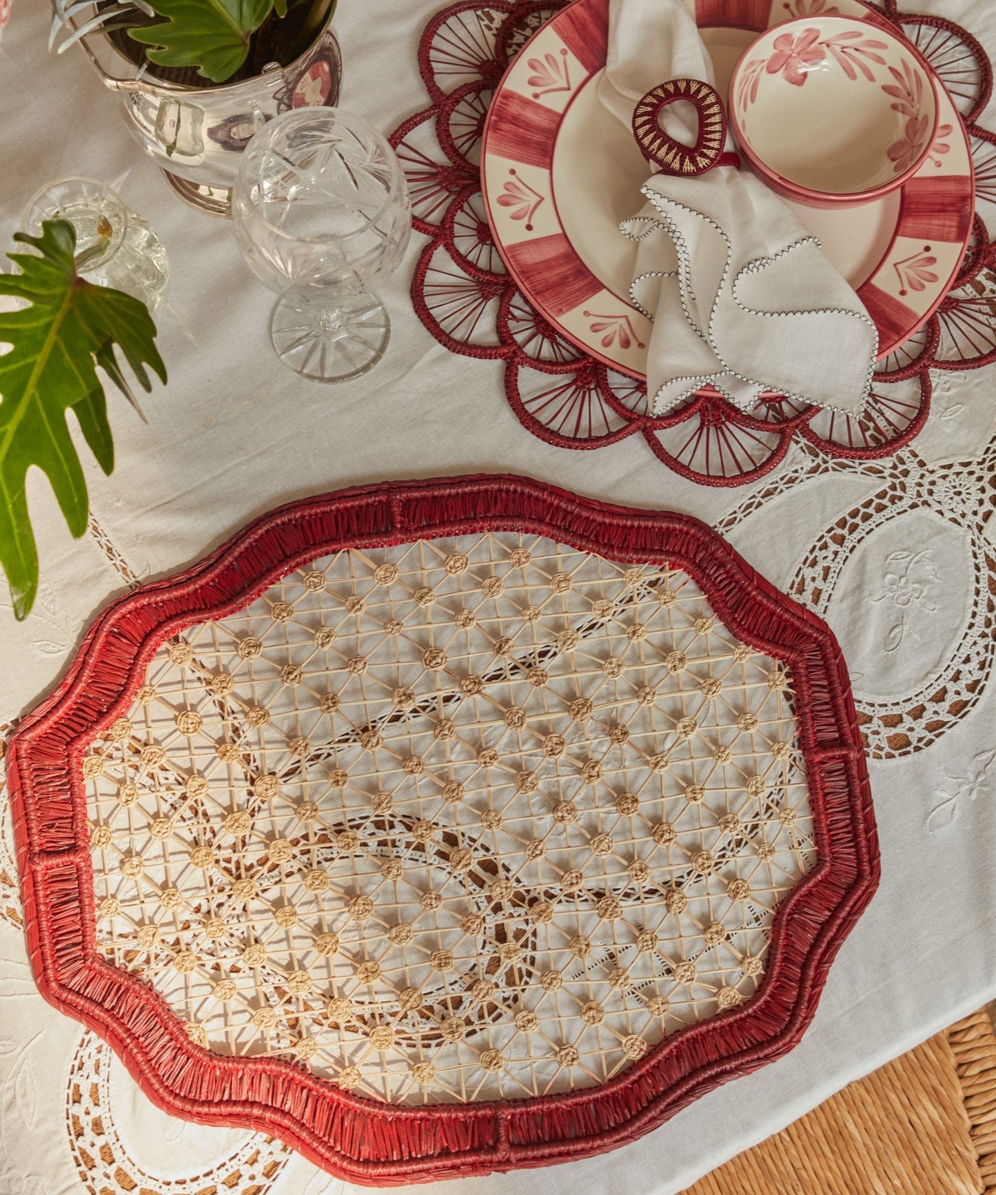 Deco geometric placemat in marsala, handwoven iraca palm, overhead view