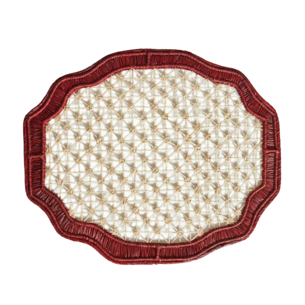 Deco geometric placemat in marsala, handwoven iraca palm, styled on a table
