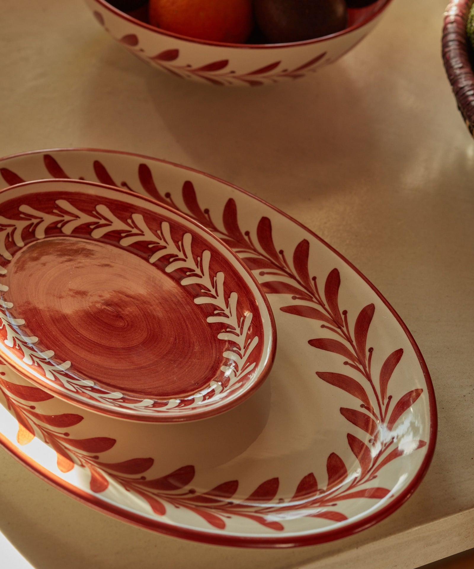 Rust red Helecho serving platters with freehand white fern wreath, hand-painted ceramic