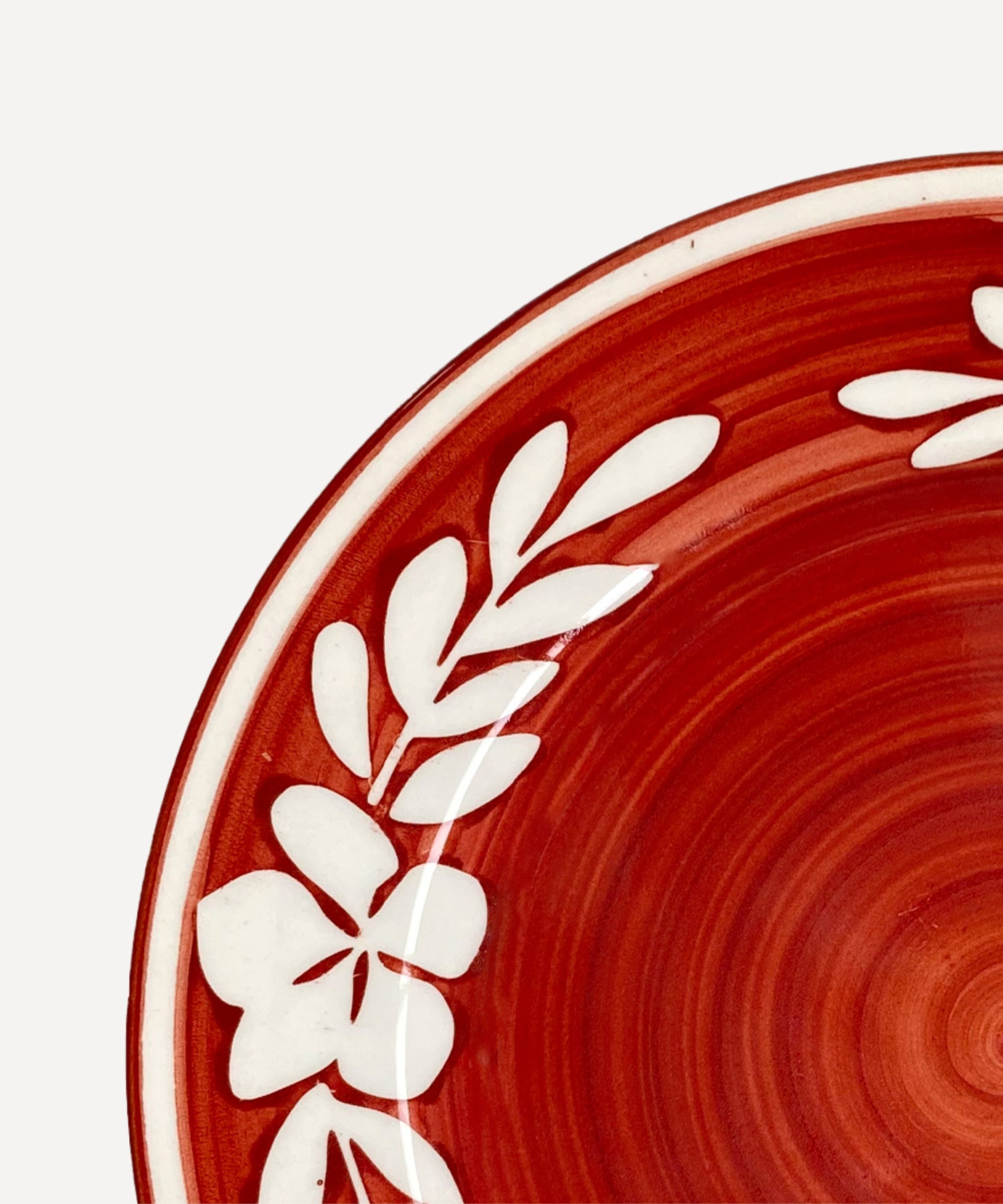 Dark Flor Side Plate in Rust Red, white floral on a deep ground — styled on a table