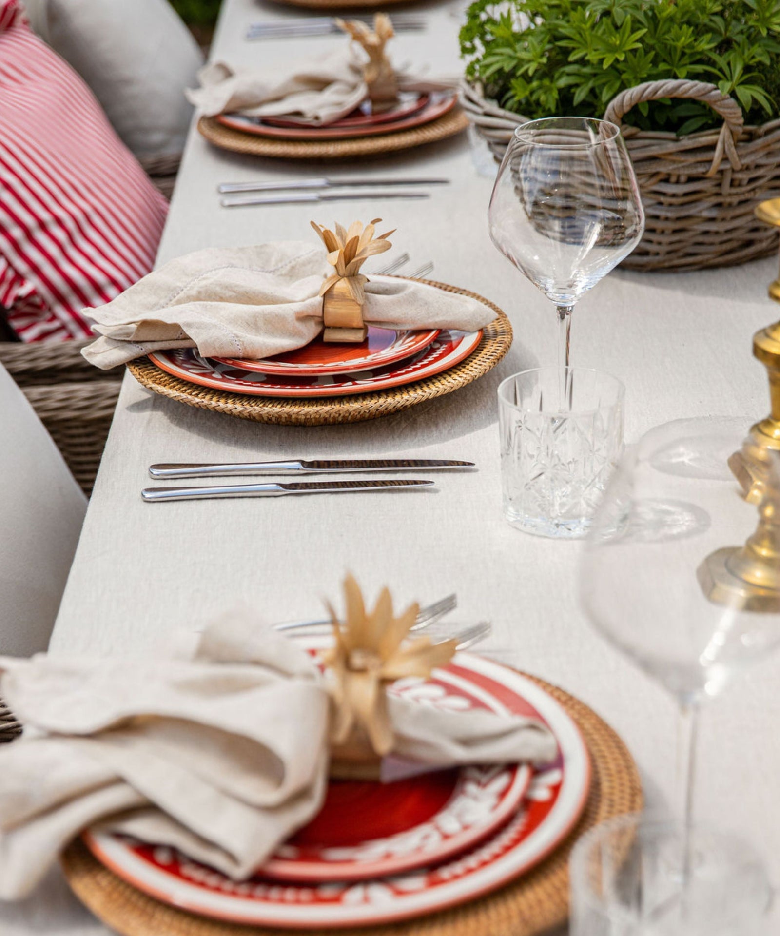 Dark Flor Side Plate in Rust Red, white floral on a deep ground — on a table setting