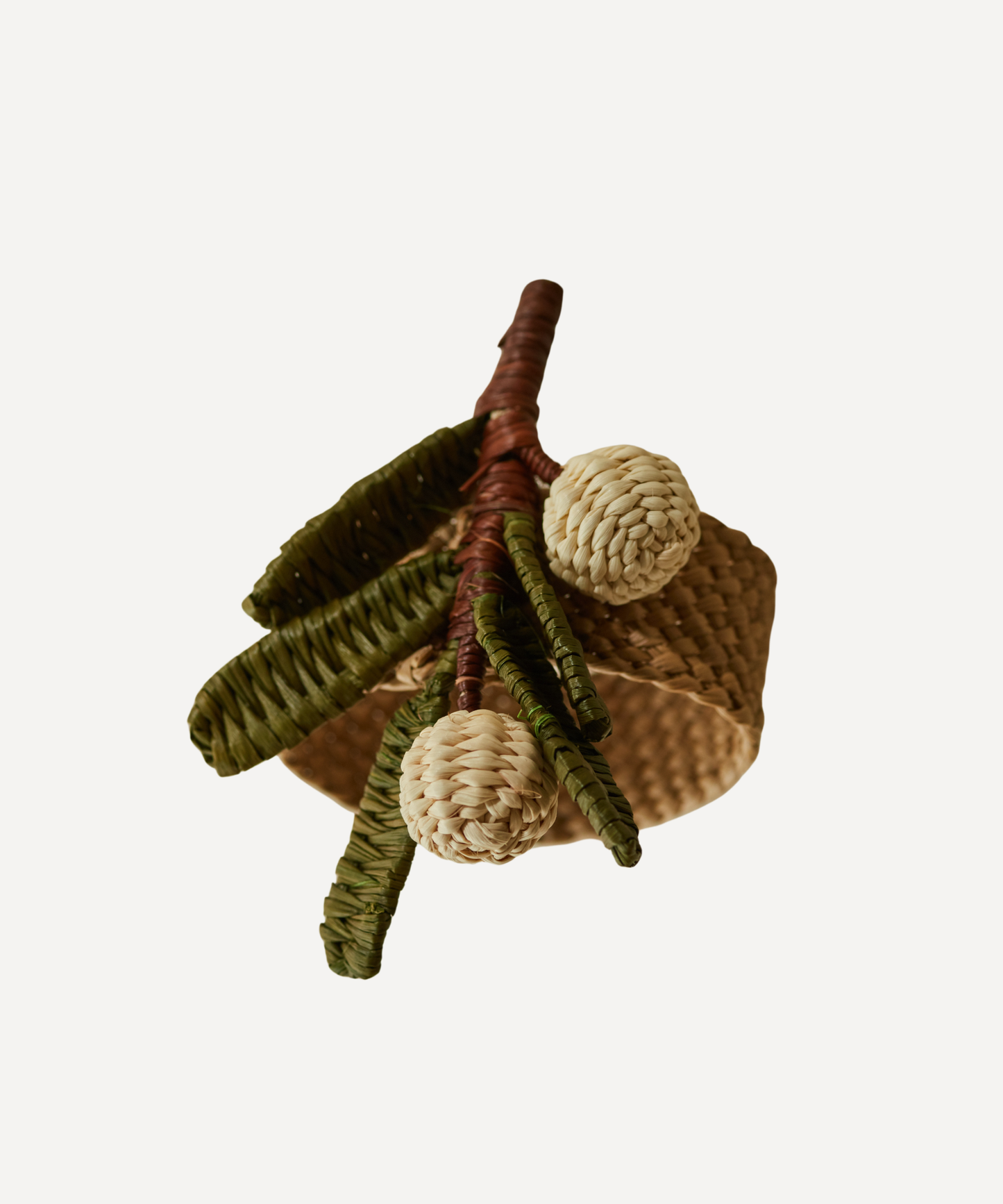 Mistletoe napkin ring, handwoven iraca palm, holding a folded napkin