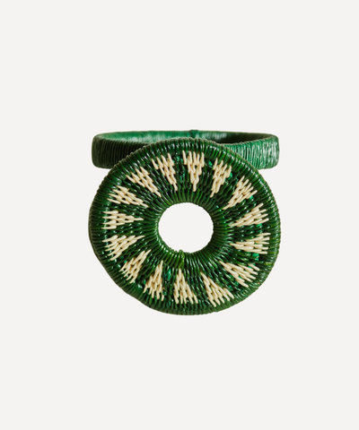 Sol Werregue napkin ring in green, handwoven werregue palm, holding a folded napkin