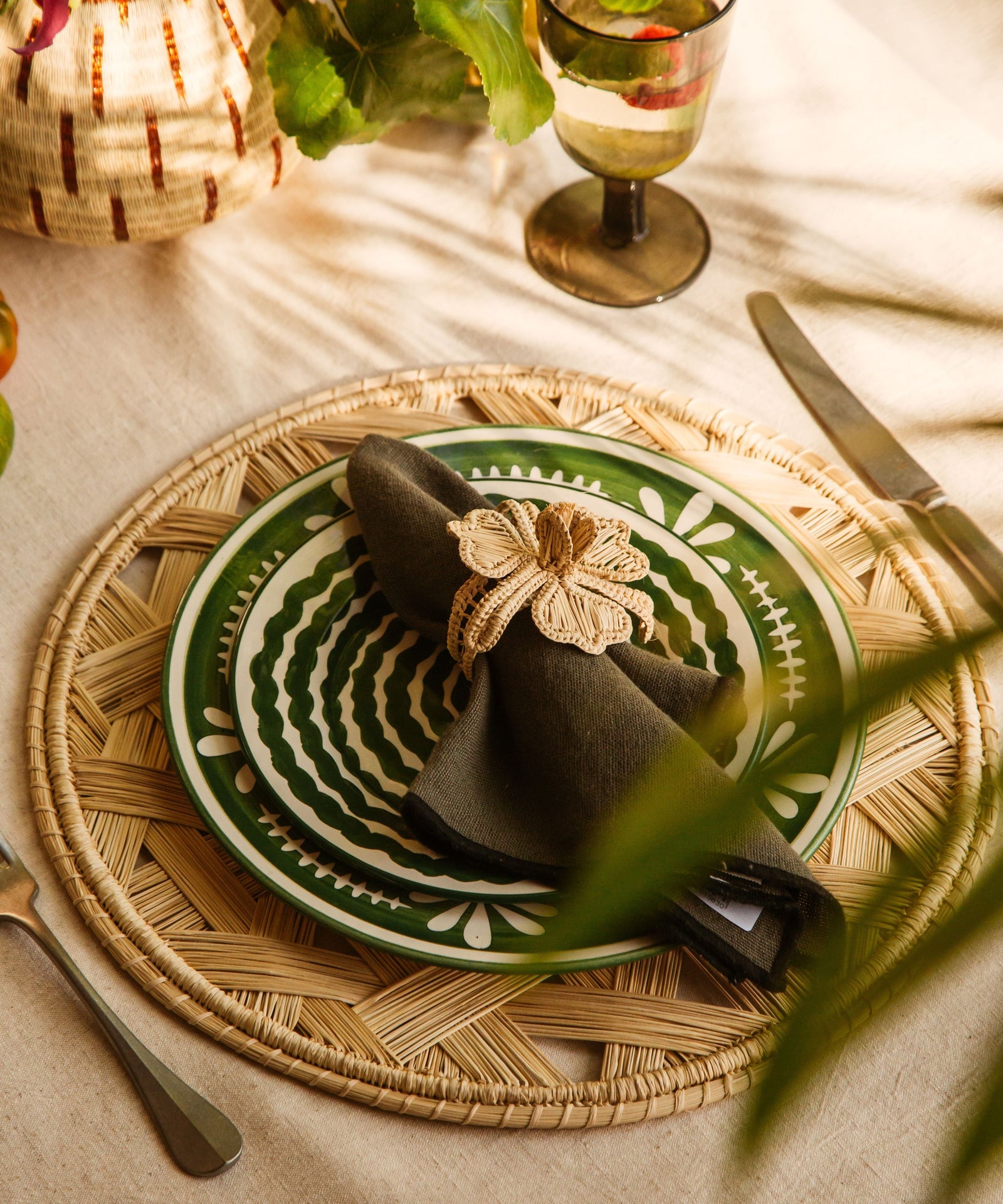 Flor Dinner Plate in Fern Green, hand-painted floral ceramic — on a table setting