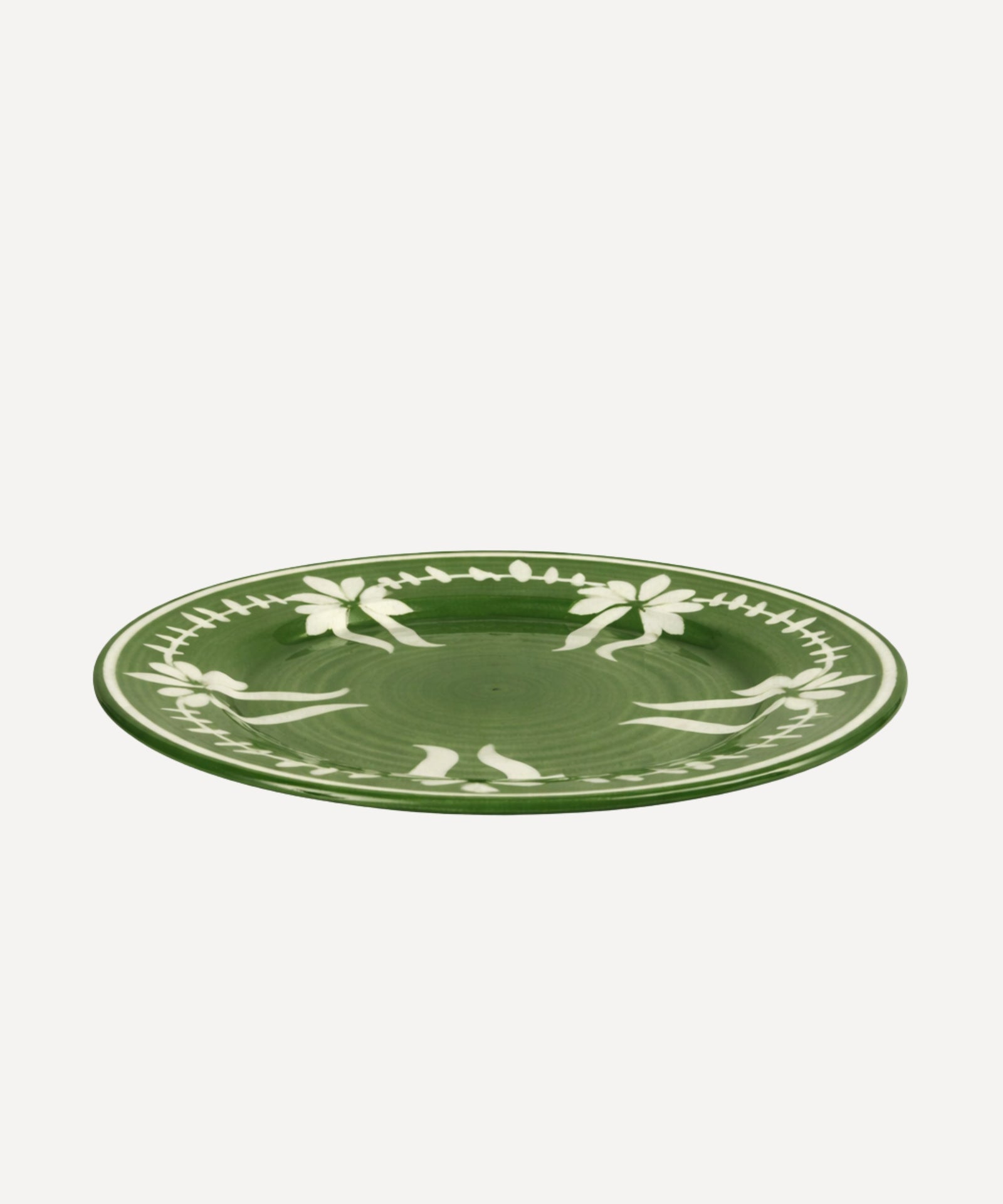Flor Dinner Plate in Fern Green, hand-painted floral ceramic — styled on a table