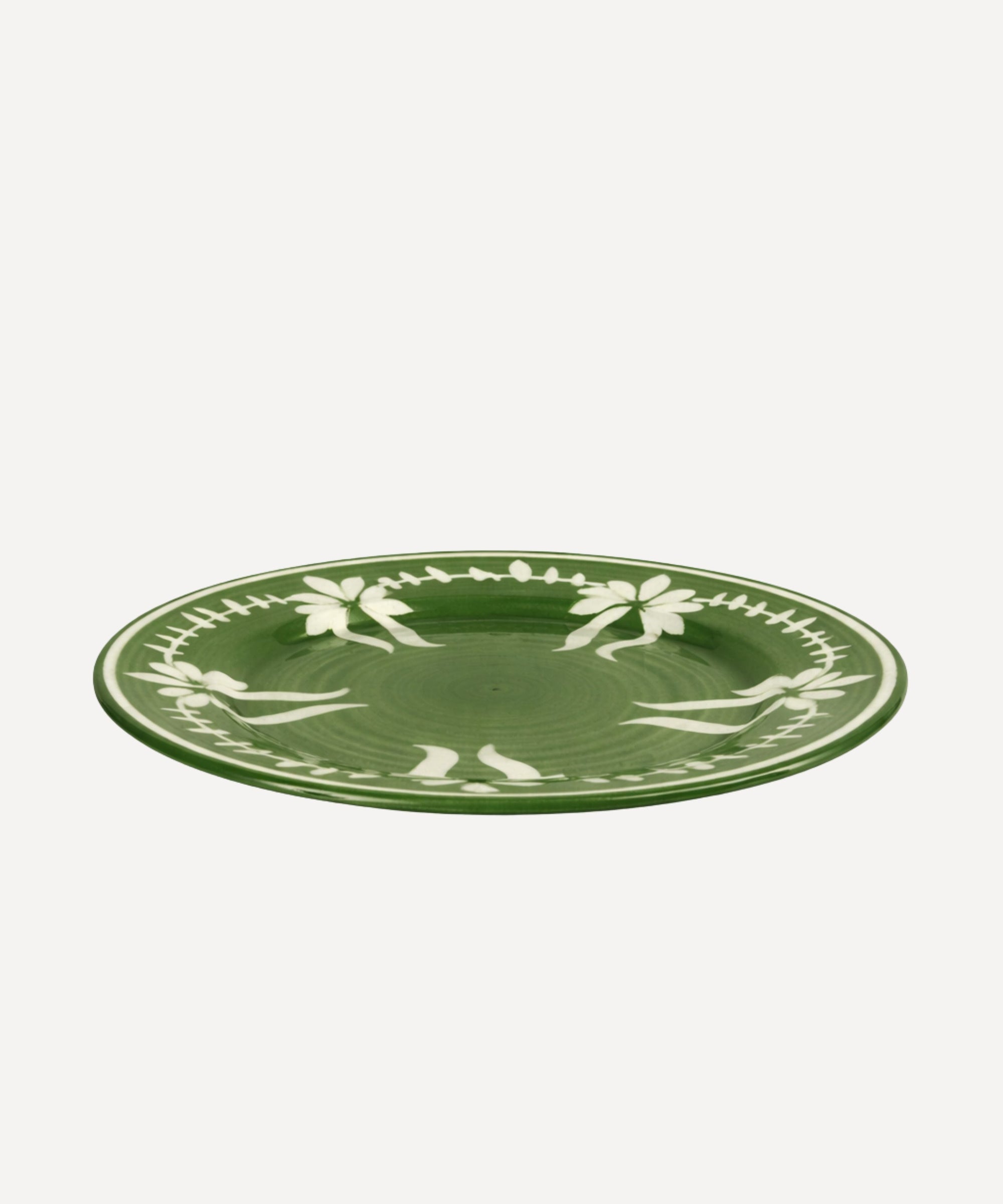 Flor Dinner Plate in Fern Green, hand-painted floral ceramic — styled on a table