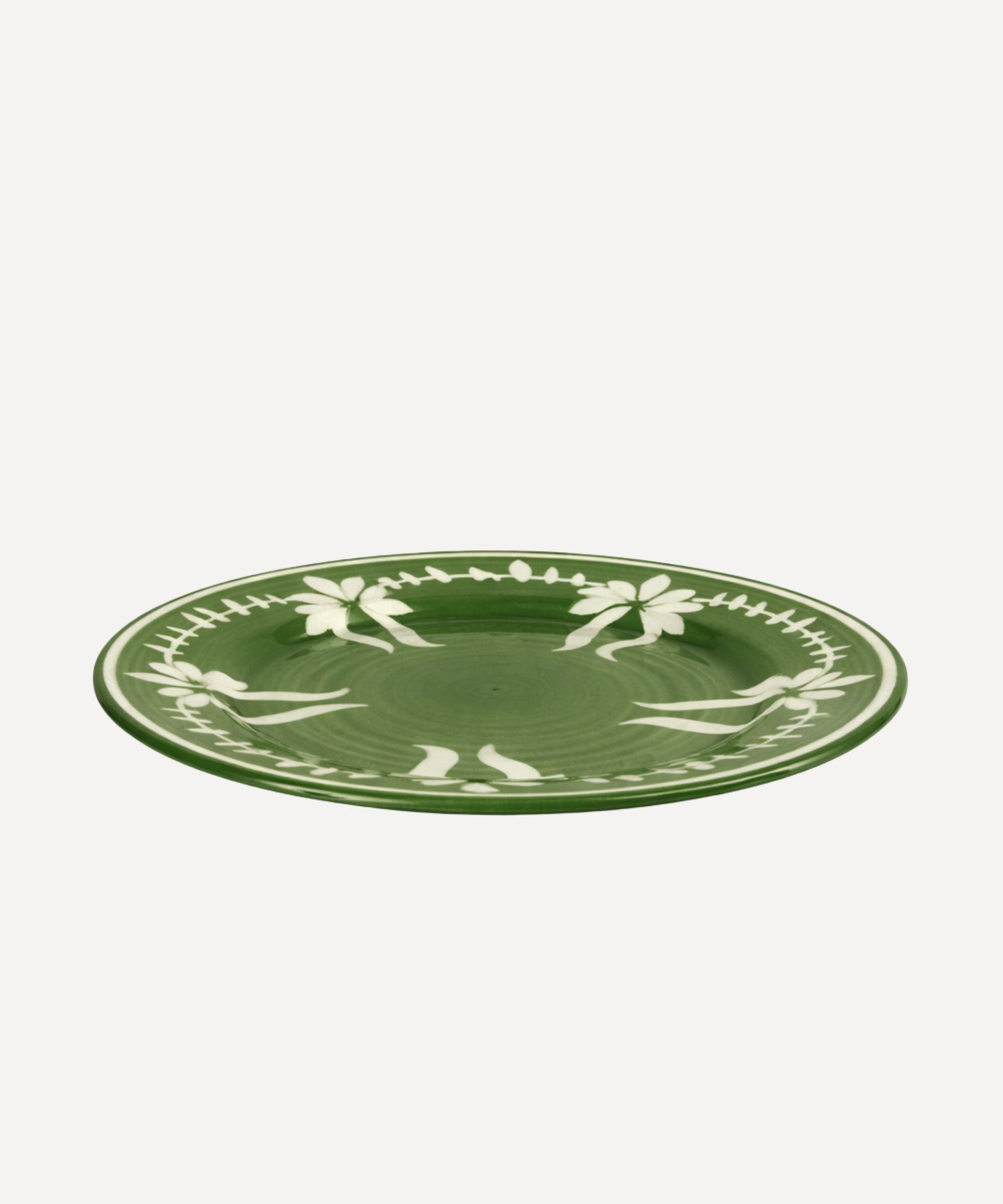 Flor Dinner Plate in Fern Green, hand-painted floral ceramic — styled on a table