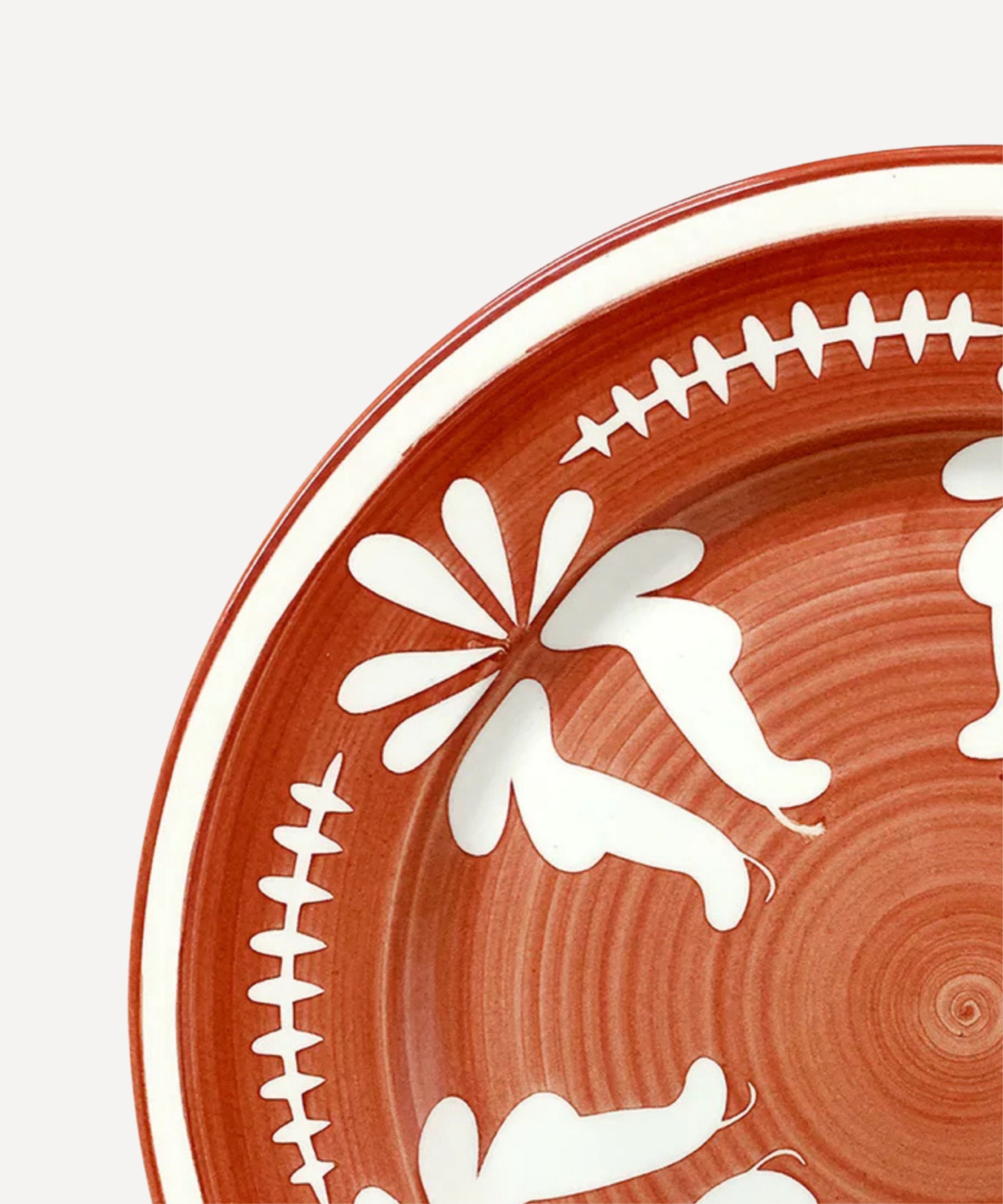 Flor Dinner Plate in Rust Red, hand-painted floral ceramic — styled on a table