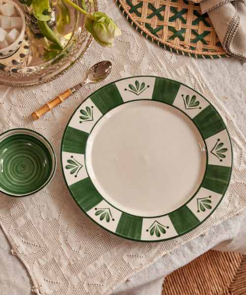 Flor de Lis Dinner Plate in Fern Green, floral ceramic — on a table setting