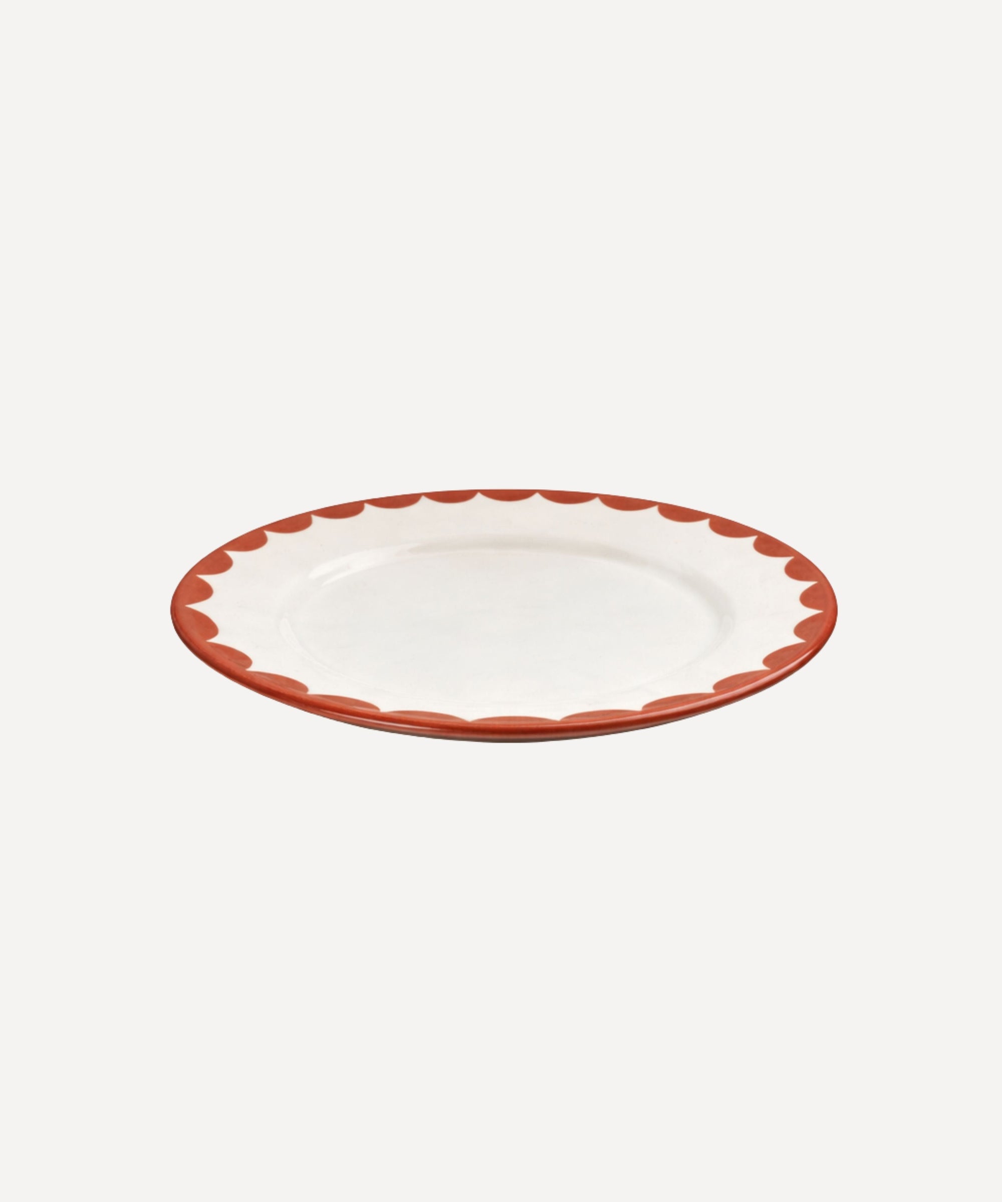 Cascos Side Plate in Rust Red, scalloped ceramic — styled on a table